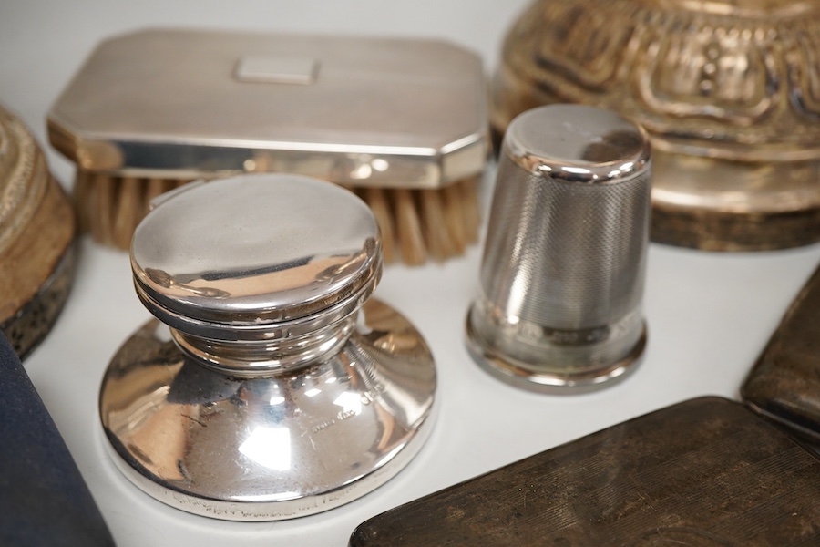 A George V silver top opening cigarette case, Birmingham, 1923, 83mm, together with a silver mounted hair brush, one other silver cigarette case, a silver mounted cigar cutter, a silver mounted inkwell, a large silver th